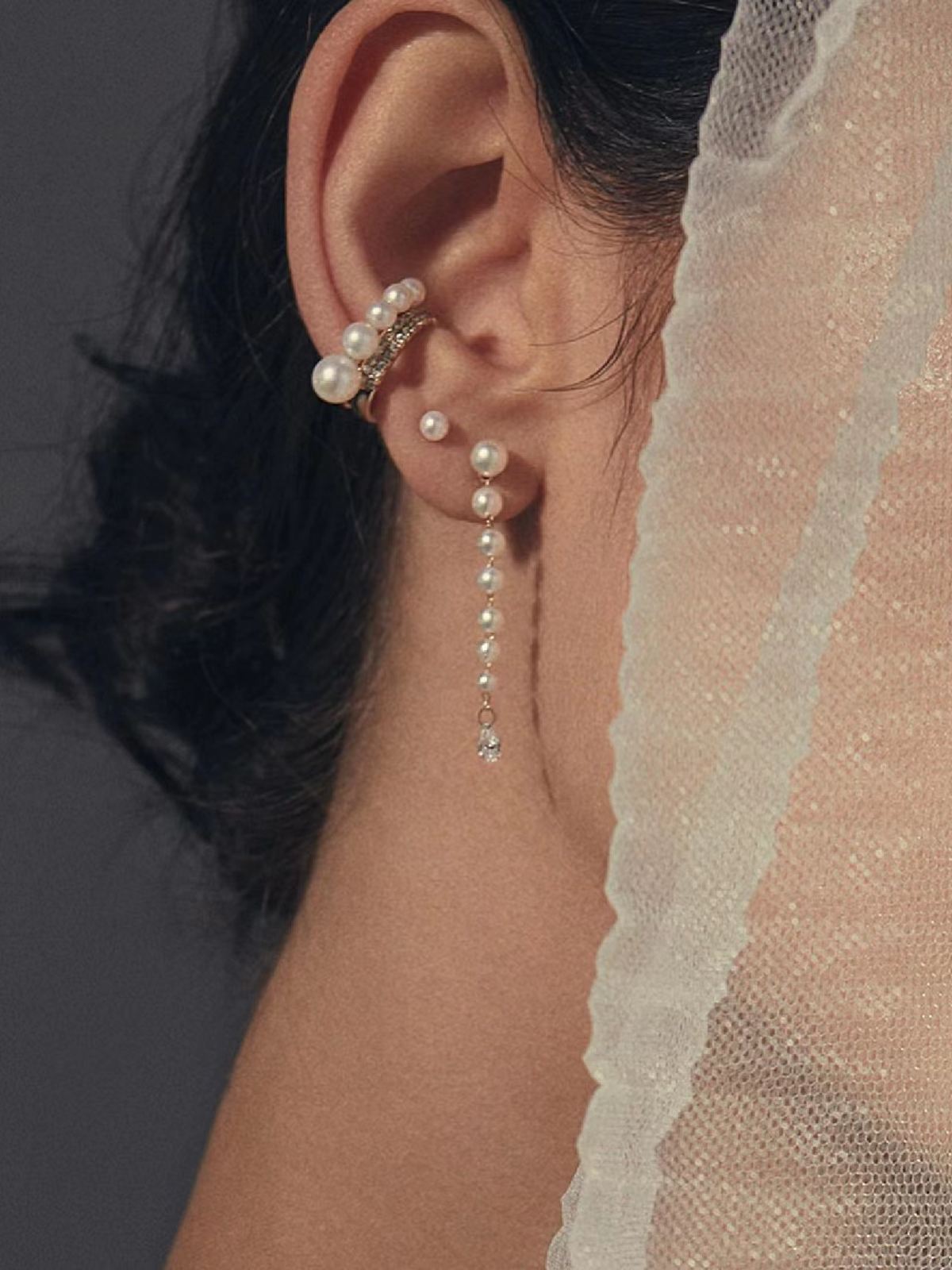 Freshwater pearl ear cuff and pearl drop chain earrings worn with a bridal veil