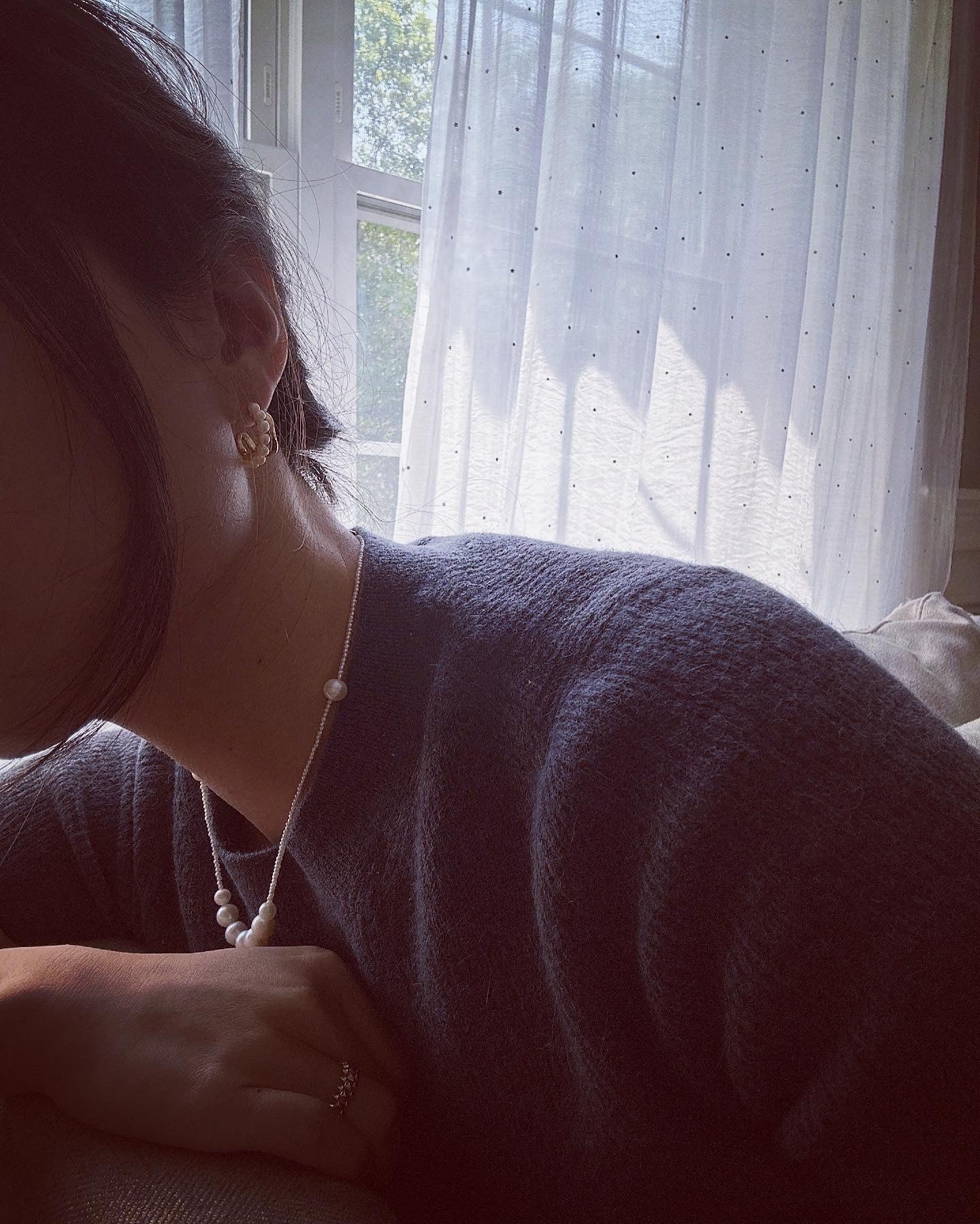 Bead pearl hoop earrings with a pearl necklace and ring on a person.