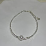 Freshwater pearl silver bracelet with a heart charm.