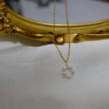 A gold-plated necklace with a pendant of five freshwater pearls arranged in a flower shape.