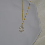 Gold-plated necklace with a pendant of five freshwater pearls arranged in a flower shape.