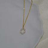 Gold-plated necklace with a pendant of five freshwater pearls arranged in a flower shape.