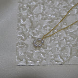 A gold-plated necklace features a pendant of five freshwater pearls arranged in a flower shape.