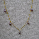 Dainty gold-plated necklace with five purple freshwater pearls.