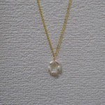 A gold-plated necklace features a pendant of five freshwater pearls arranged in a flower shape.