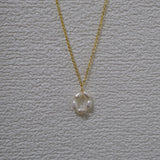 A gold-plated necklace features a pendant of five freshwater pearls arranged in a flower shape.