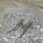 Elegant pearl bow dangle earrings with a silver-plated chain.