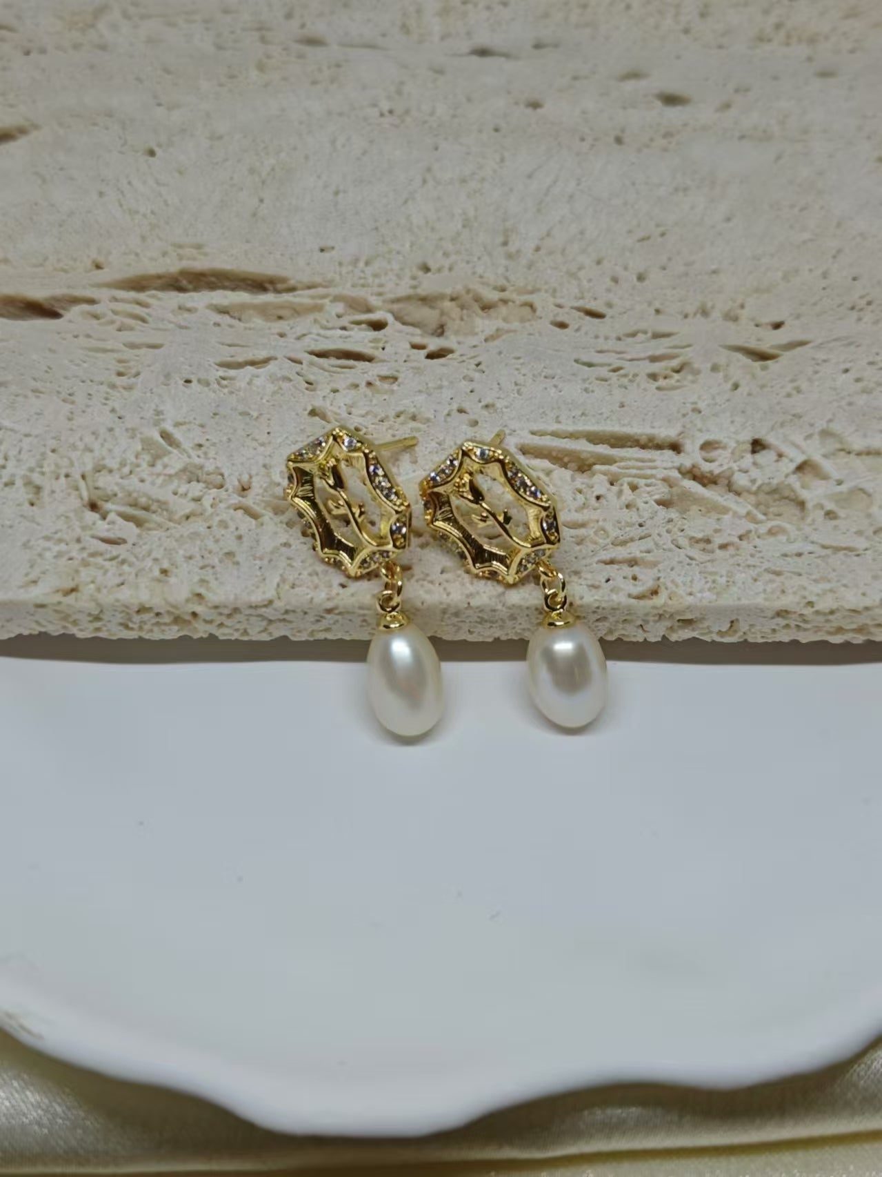 Gold-plated earrings with a vintage design, featuring a rose and a dangling freshwater pearl.