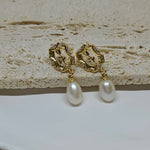 Gold-plated earrings with a vintage design, clear stones, and dangling freshwater pearls.