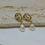 Gold-plated earrings with a vintage design, clear stones, and dangling freshwater pearls.