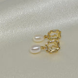 Gold-plated earrings with freshwater pearls and a vintage rose design.