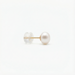 A single pearl stud earring with a gold post and a clear plastic backing.