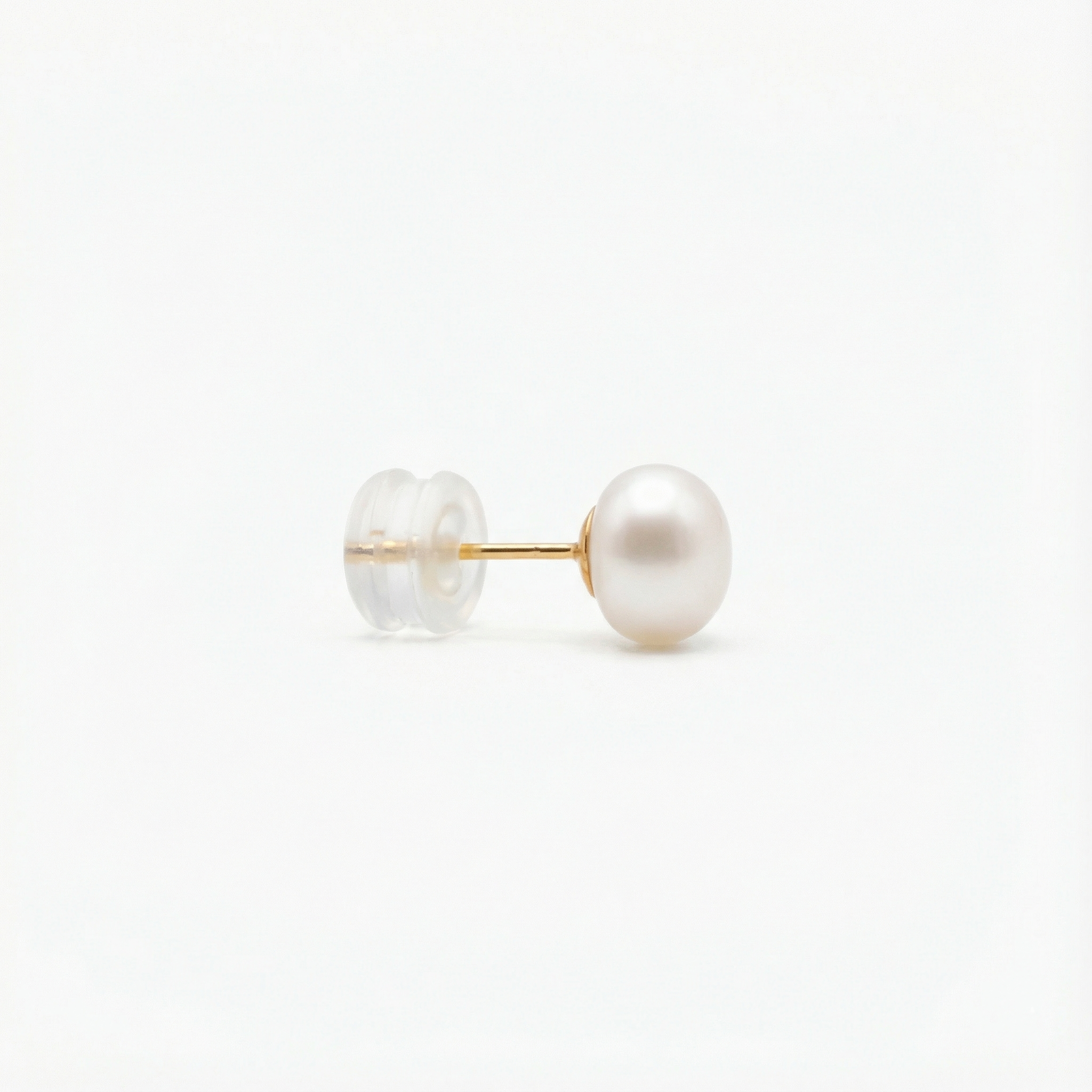 A single pearl stud earring with a gold post and a clear plastic backing.