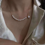 A rice-shaped pearl necklace with a gold-plated chain and a single drop pearl.