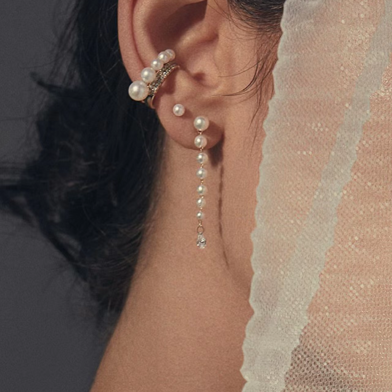 Freshwater pearl ear cuff and pearl drop chain earrings worn with a bridal veil