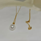 A gold chain necklace with an off-round white freshwater pearl pendant.