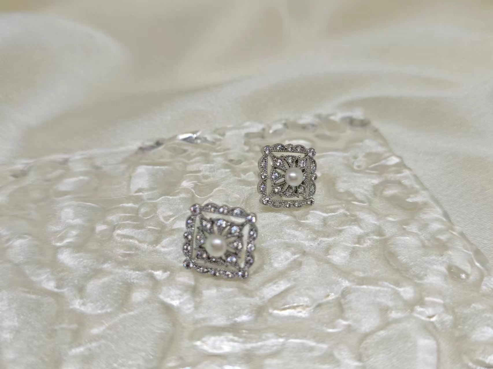 Two silver quadrate vintage stud earrings with freshwater pearls and diamonds.