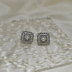 Silver quadrate vintage stud earrings with a central freshwater pearl and surrounding diamonds.