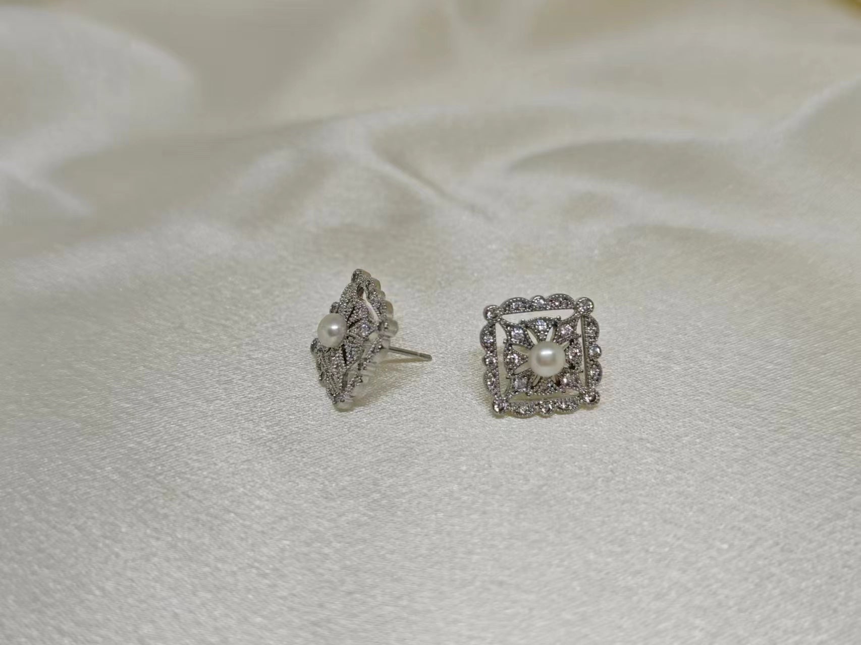 Two silver quadrate vintage stud earrings with freshwater pearls and diamonds.