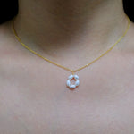 Gold-plated necklace with a pendant of five freshwater pearls arranged in a flower shape.
