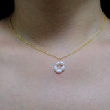 Gold-plated necklace with a pendant of five freshwater pearls arranged in a flower shape.