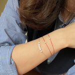A dainty gold-plated CAELLIA bracelet featuring a row of natural freshwater pearls.