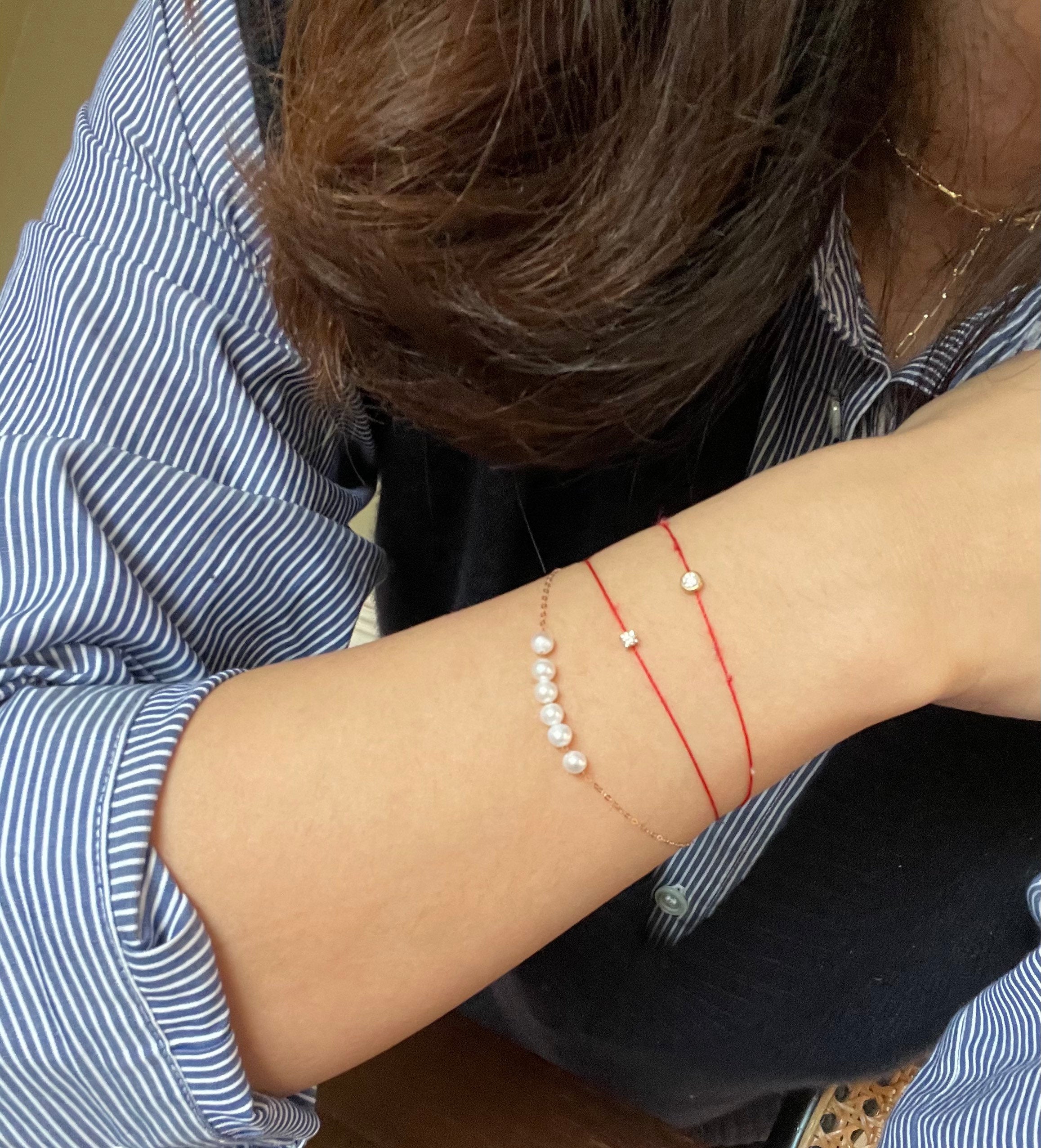 A dainty gold-plated CAELLIA bracelet featuring a row of natural freshwater pearls.