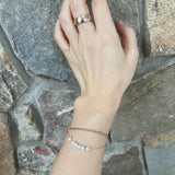 A CAELLIA dainty gold-plated chain bracelet featuring a row of natural freshwater pearls.