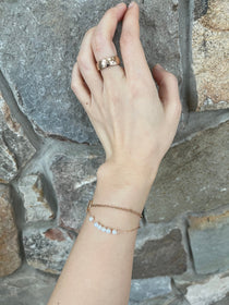 A CAELLIA dainty gold-plated chain bracelet featuring a row of natural freshwater pearls.