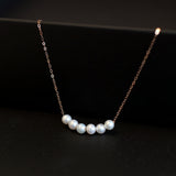 CAELLIA dainty gold-plated chain bracelet featuring five natural freshwater pearls.