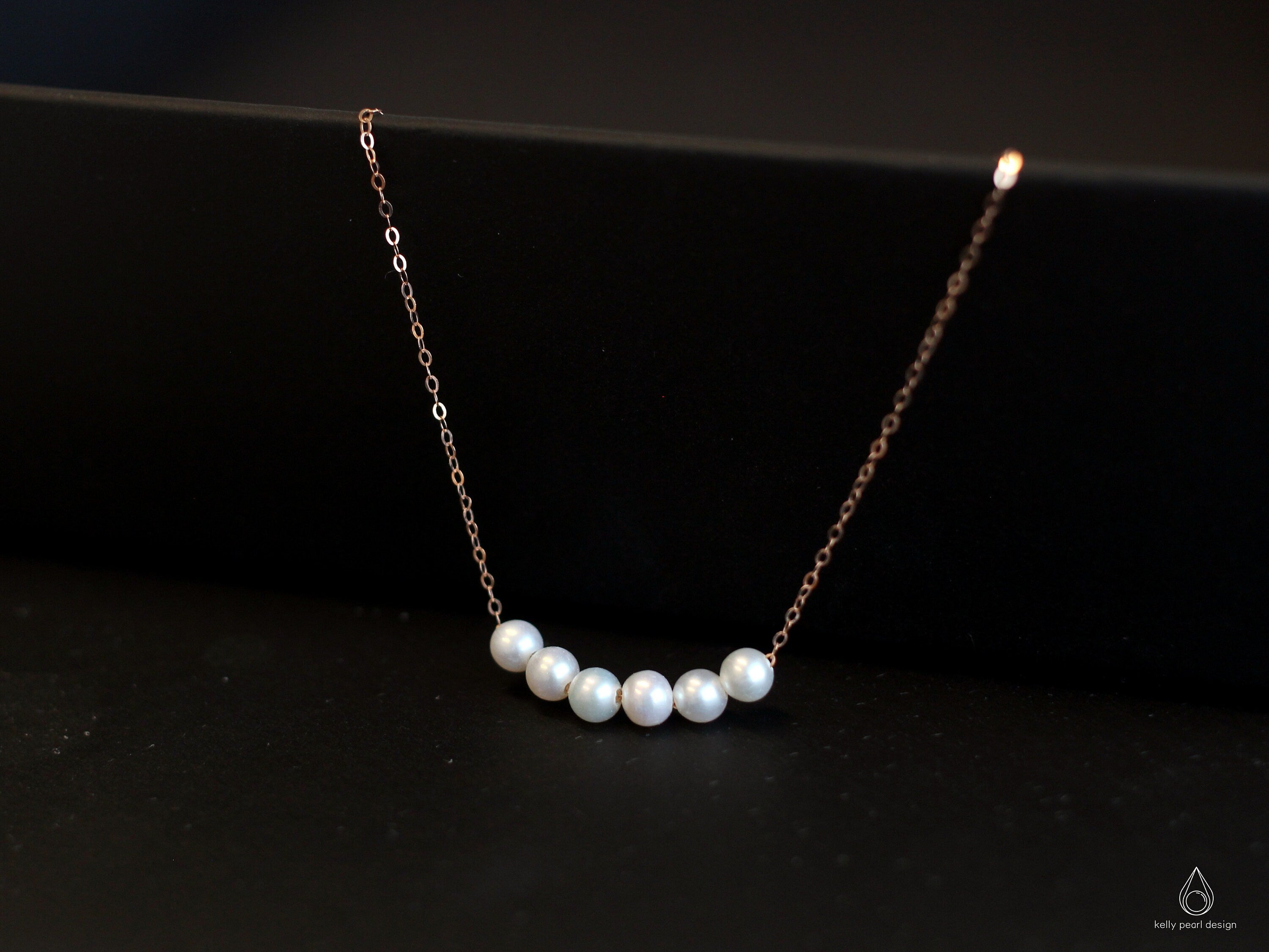 CAELLIA dainty gold-plated chain bracelet featuring five natural freshwater pearls.