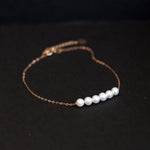 CAELLIA dainty gold-plated chain bracelet featuring six natural freshwater pearls.