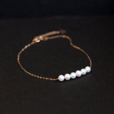 CAELLIA dainty gold-plated chain bracelet featuring six natural freshwater pearls.