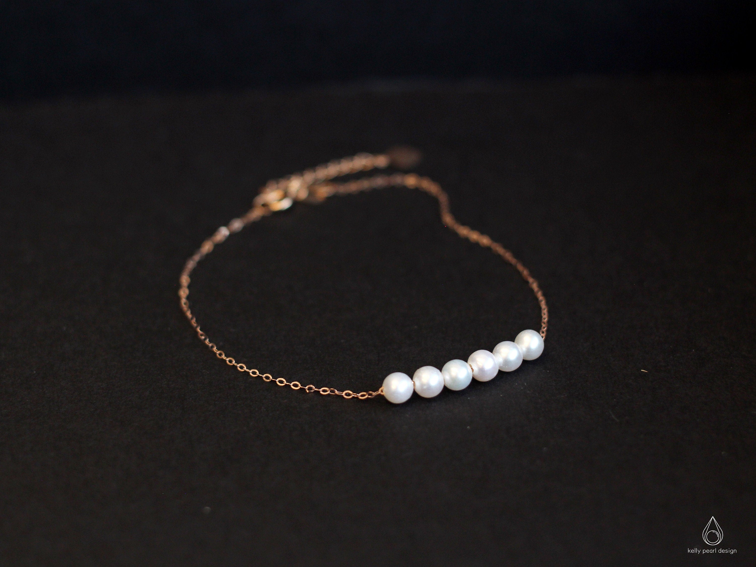 CAELLIA dainty gold-plated chain bracelet featuring six natural freshwater pearls.
