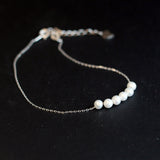 CAELLIA dainty freshwater pearl bracelet featuring five pearls on a delicate silver-tone chain.