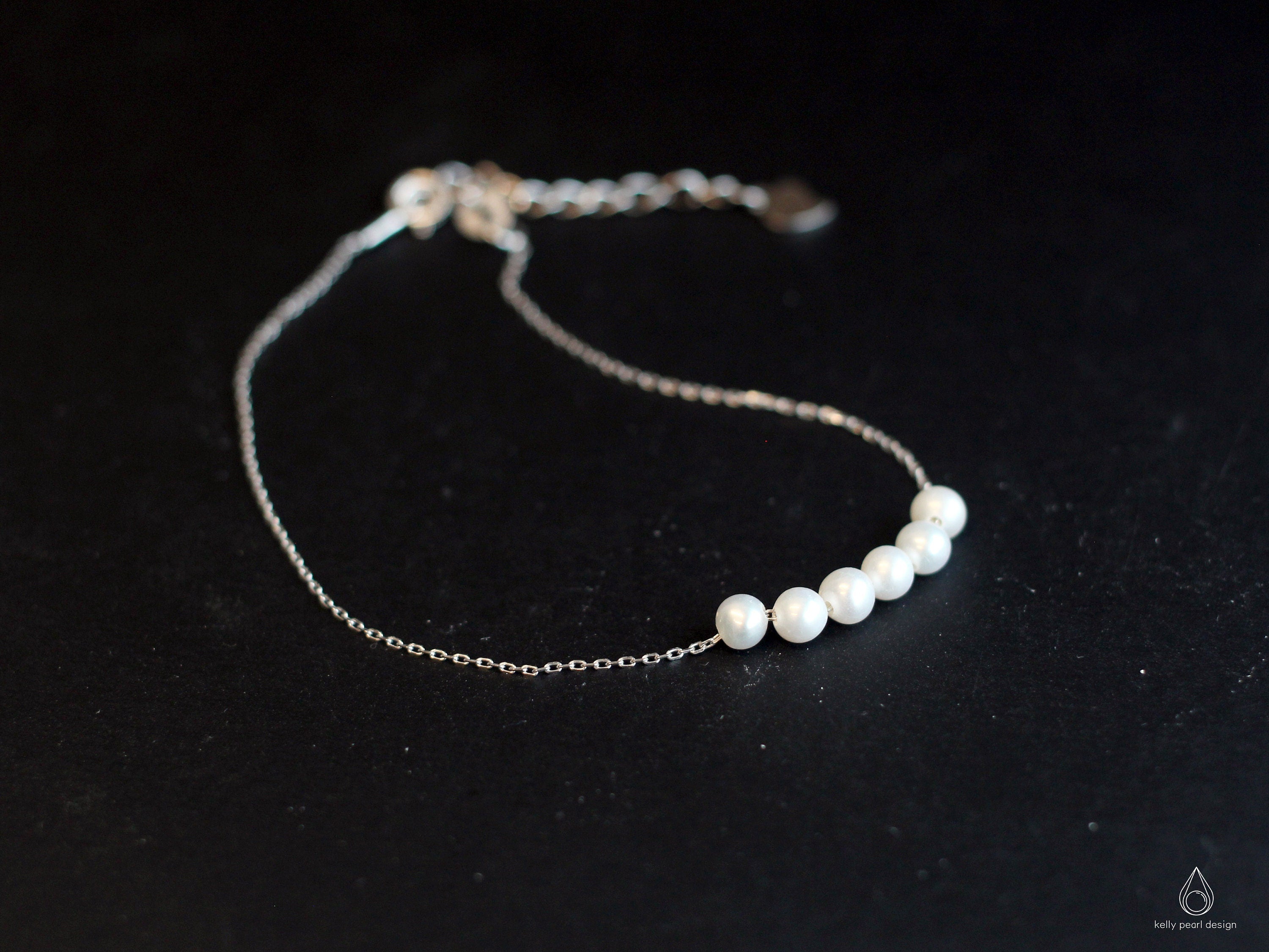 CAELLIA dainty freshwater pearl bracelet featuring five pearls on a delicate silver-tone chain.