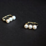Caellia 14K gold plated hoop earrings featuring three lustrous freshwater pearls.