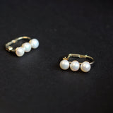 Caellia 14K gold plated hoop earrings featuring three lustrous freshwater pearls.