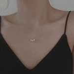 Caellia 18k gold dainty choker necklace featuring three small freshwater pearls.