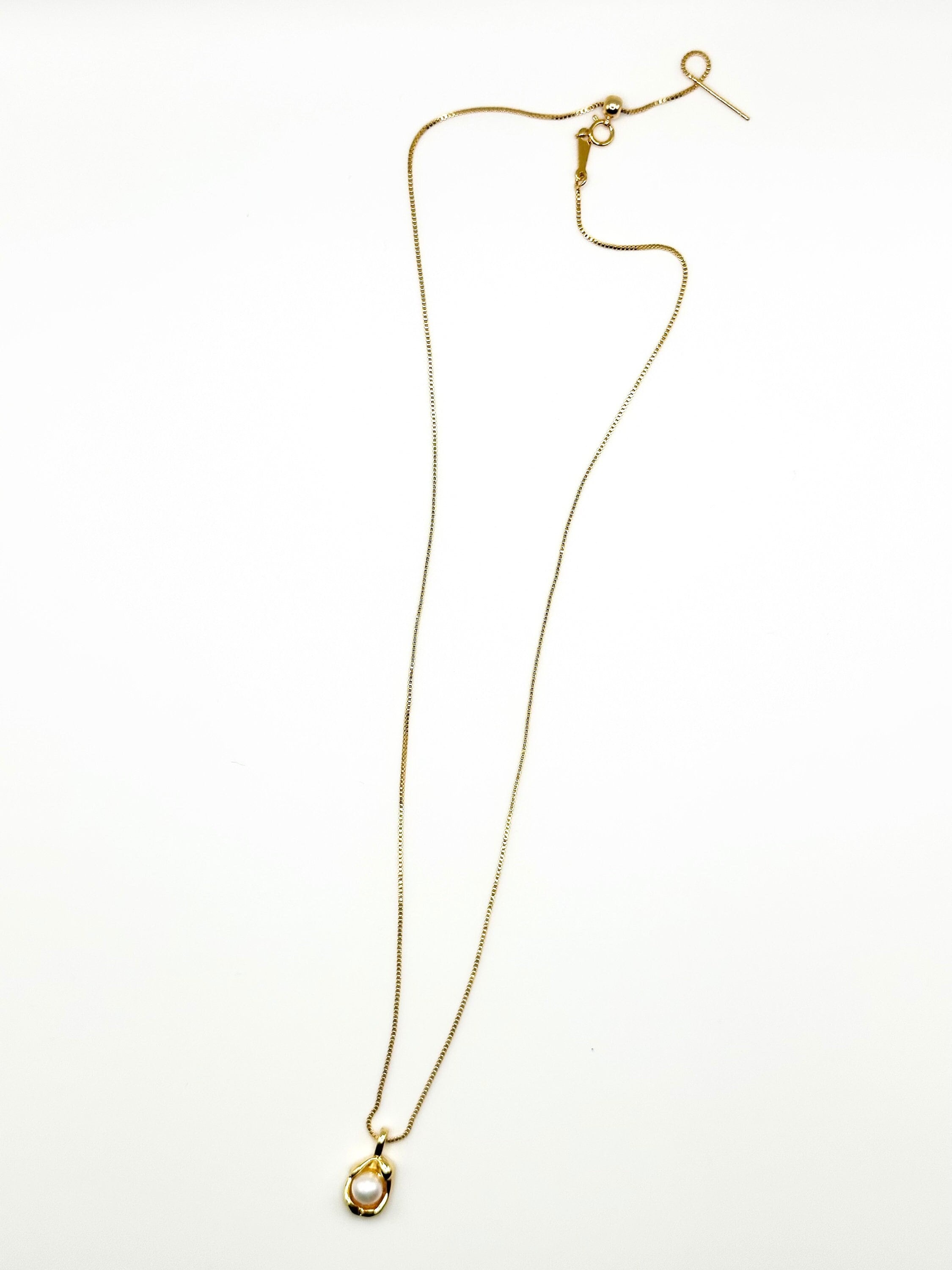 Caellia 14K gold dainty freshwater pearl pendant necklace on a delicate chain.