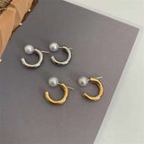 Caellia hoop earrings featuring a freshwater pearl on a gold or silver tone band.