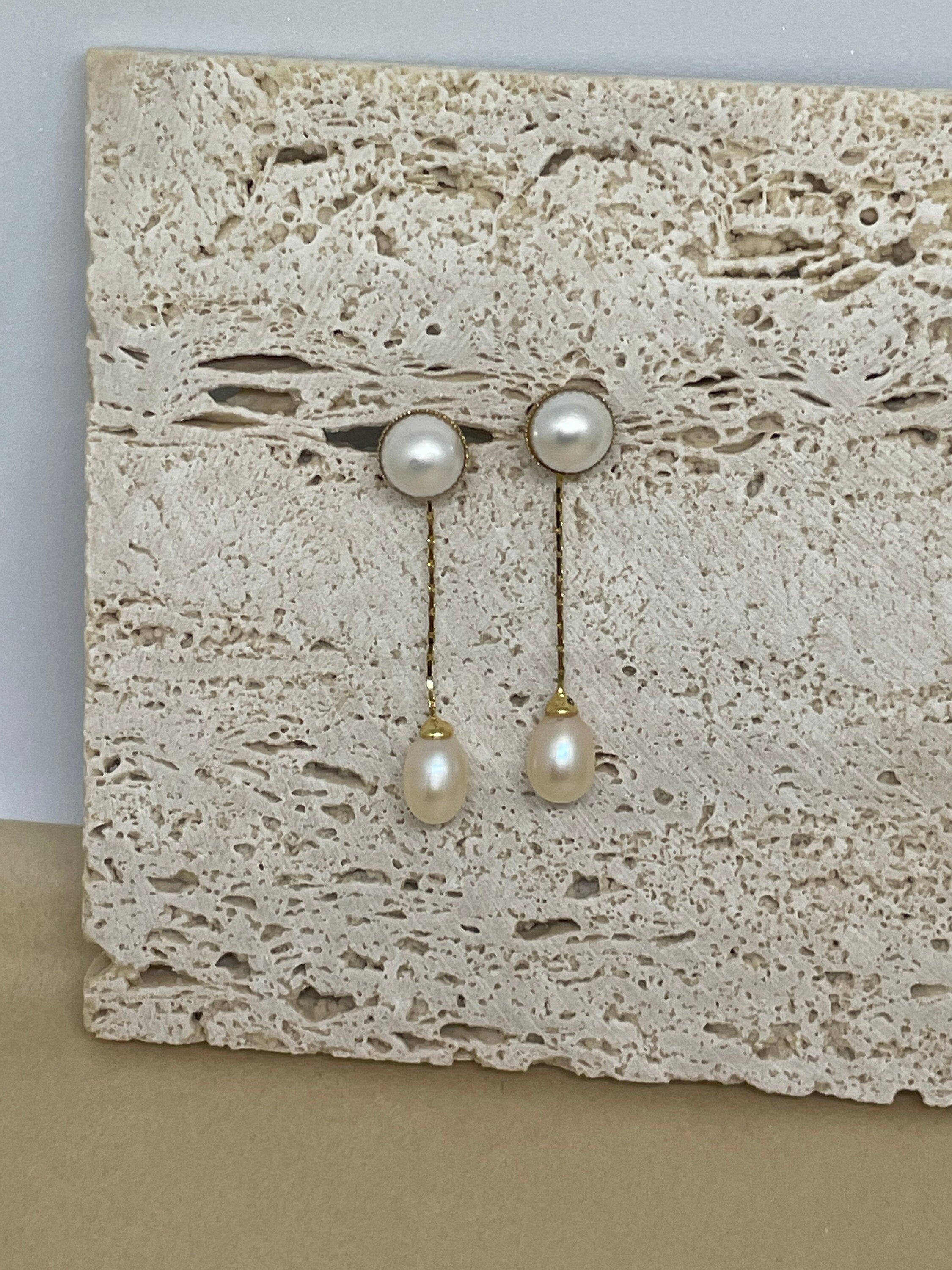 CAELLIA gold-plated dangle earrings featuring a round pearl stud and a teardrop pearl drop.