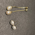 CAELLIA gold-plated pearl dangle earrings featuring teardrop pearls on delicate chains.