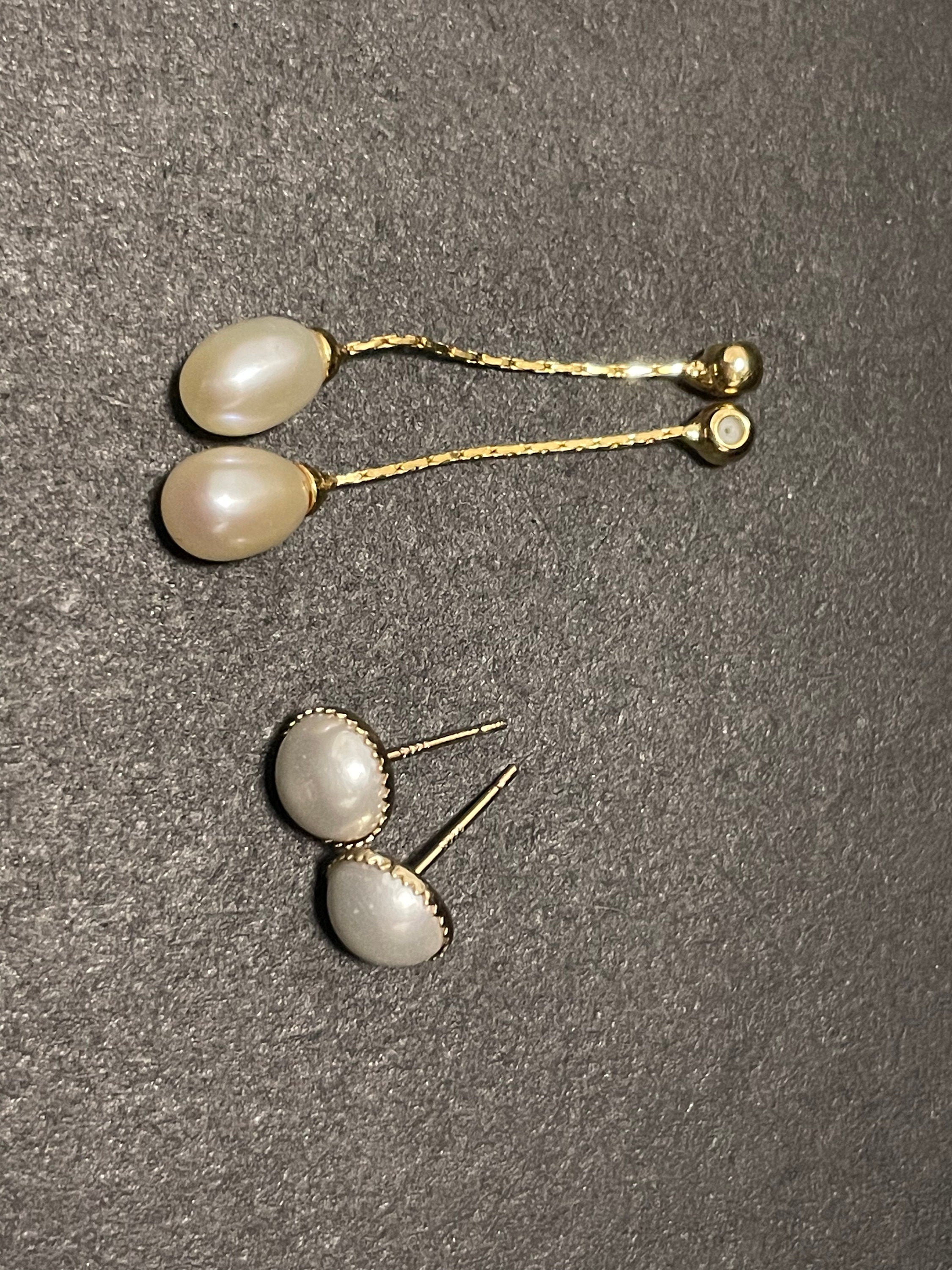 CAELLIA gold-plated pearl dangle earrings featuring teardrop pearls on delicate chains.