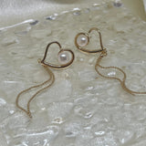 CAELLIA heart-shaped 18k gold plated dangle earrings featuring a central pearl and delicate chain.