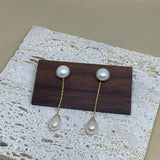 CAELLIA gold-plated dangle earrings featuring a round pearl stud and a teardrop pearl drop.