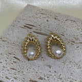 CAELLIA vintage style water drop shaped earrings featuring a freshwater pearl in a gold setting.