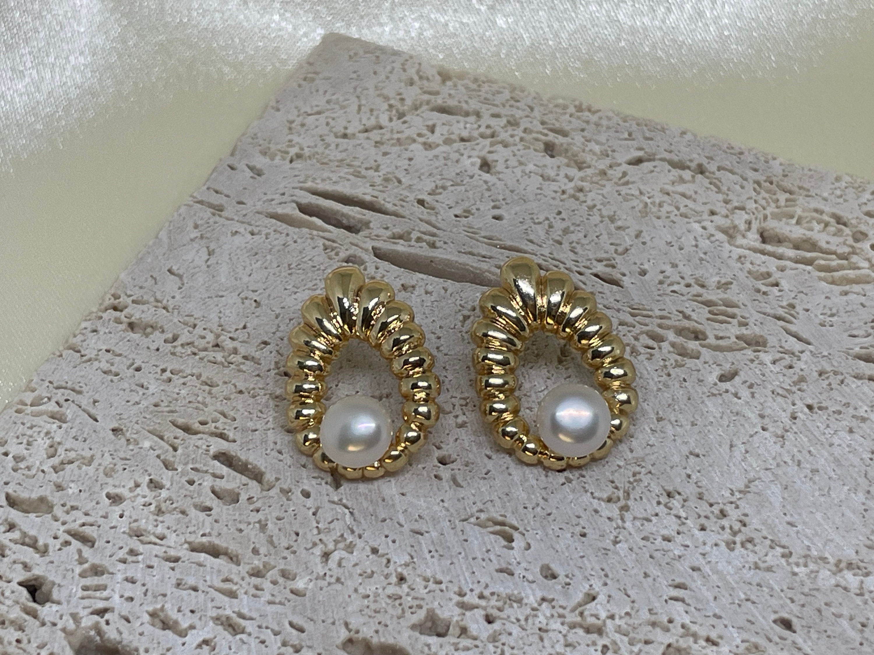 CAELLIA vintage style water drop shaped earrings featuring a freshwater pearl in a gold setting.