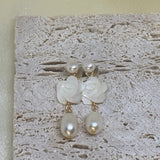 Caellia 14K gold dangle earrings featuring a camellia flower stud and a freshwater pearl drop.