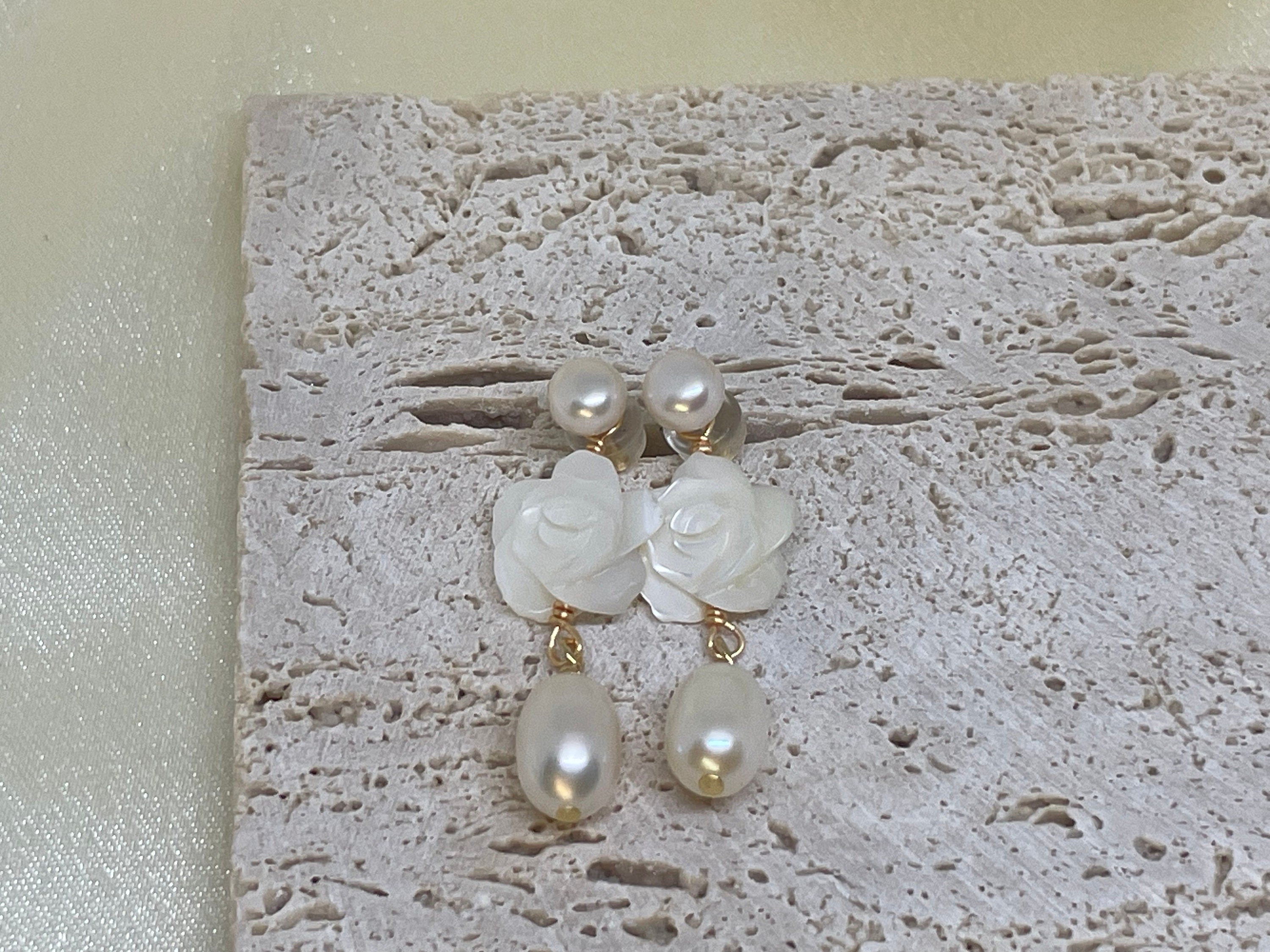 Caellia 14K gold dangle earrings featuring a camellia flower stud and a freshwater pearl drop.